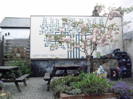 Compton's Yard Charitable Trust's Garden in Llanidloes, with mural by Kleo Morrison